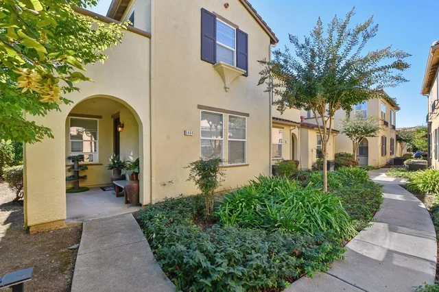a front view of a house with a garden