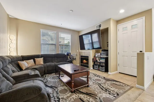a living room with furniture and a fireplace