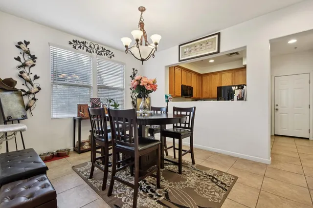 a view of a dining room with furniture and a chandelier