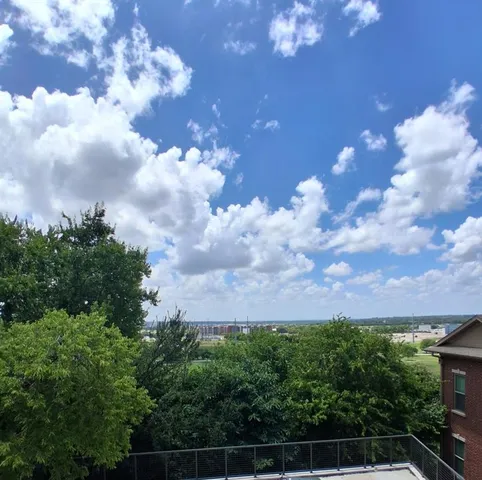 a view of walk in closet with wooden floor