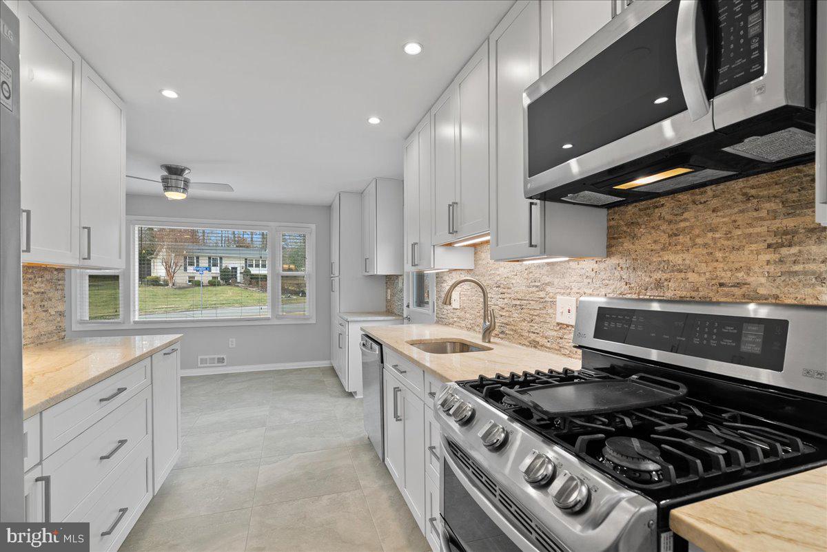 7845 Brompton Street Springfield, VA 22152 - Photo 11 of 32 a kitchen with a stove and a sink