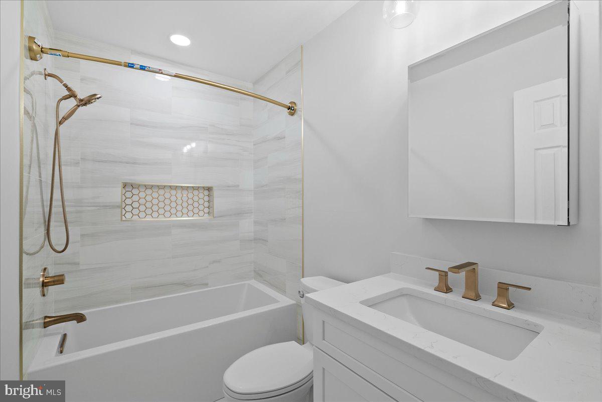 7845 Brompton Street Springfield, VA 22152 - Photo 12 of 32 a bathroom with a granite countertop sink toilet and shower