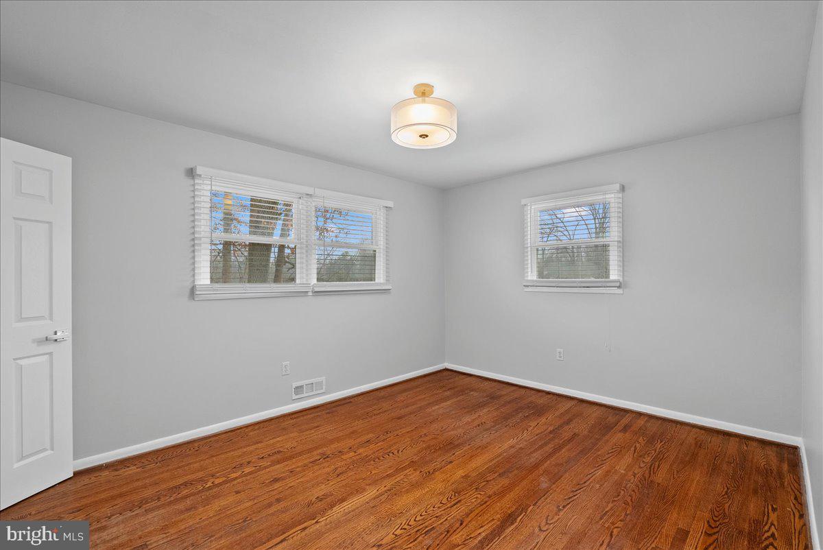 7845 Brompton Street Springfield, VA 22152 - Photo 13 of 32 a view of empty room with wooden floor