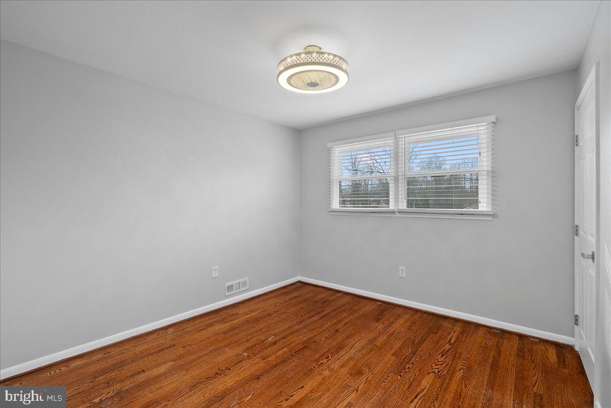 7845 Brompton Street Springfield, VA 22152 - Photo 17 of 32 a view of empty room with wooden floor and fan