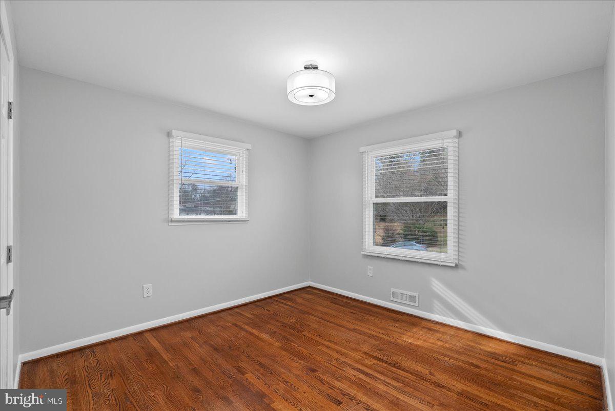 7845 Brompton Street Springfield, VA 22152 - Photo 19 of 32 an empty room with wooden floor and windows