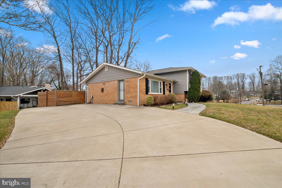 7845 Brompton Street Springfield, VA 22152 - Photo 2 of 32 a front view of a house with a yard and trees