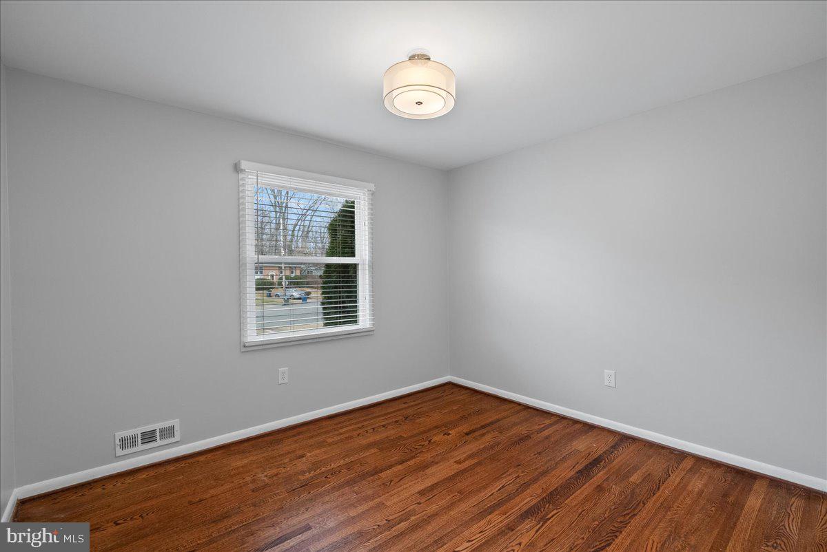 7845 Brompton Street Springfield, VA 22152 - Photo 21 of 32 an empty room with wooden floor and windows