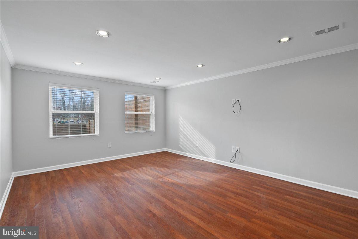 7845 Brompton Street Springfield, VA 22152 - Photo 23 of 32 a view of an empty room with wooden floor and a window