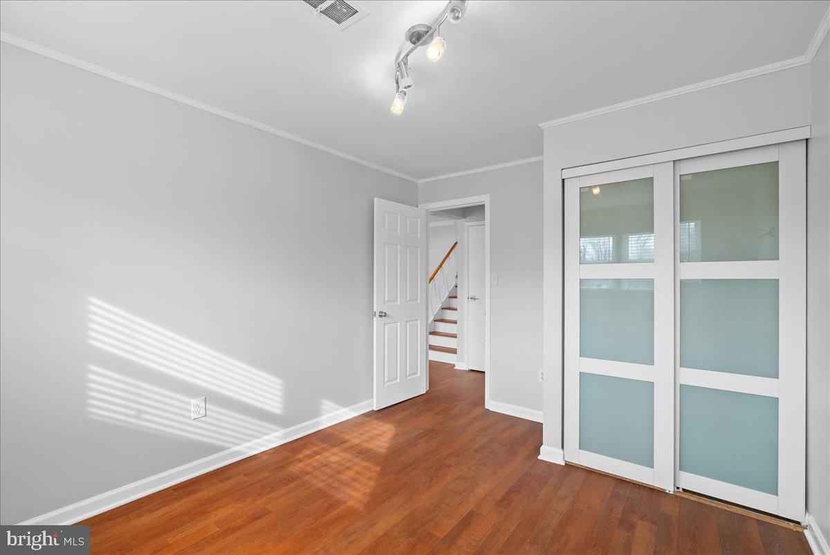 7845 Brompton Street Springfield, VA 22152 - Photo 26 of 32 a view of empty room with wooden floor and fan
