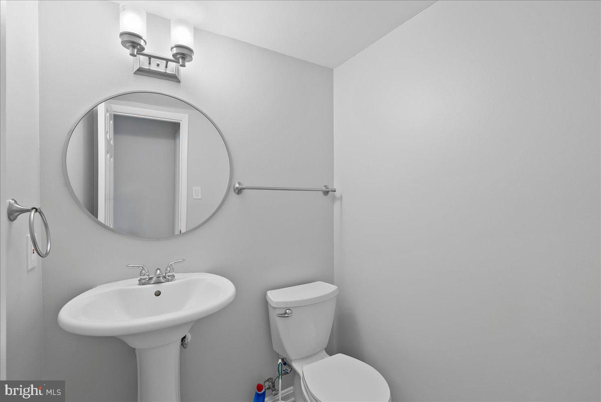 7845 Brompton Street Springfield, VA 22152 - Photo 27 of 32 a bathroom with a toilet sink and mirror