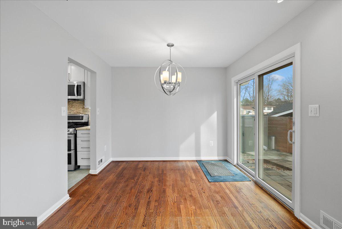 7845 Brompton Street Springfield, VA 22152 - Photo 6 of 32 a view of empty room with wooden floor and fan