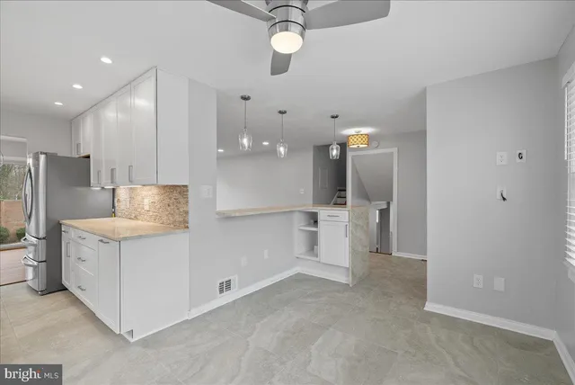 a view of a kitchen with a sink and a refrigerator