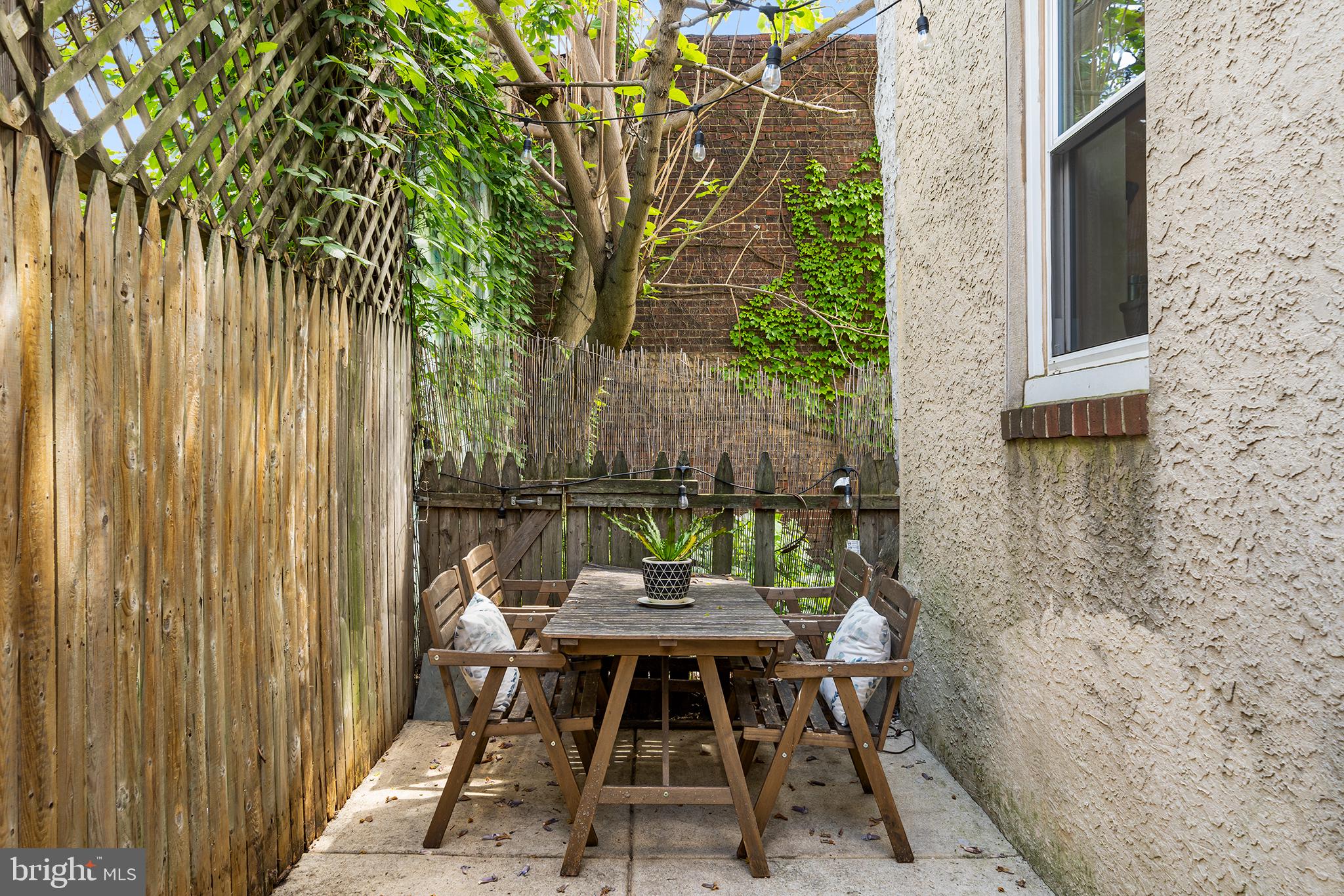 107 Master Street Philadelphia, PA 19122 - Photo 14 of 24 a backyard of a house with table and chairs