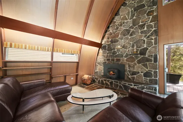 a living room with patio furniture and a wooden floor