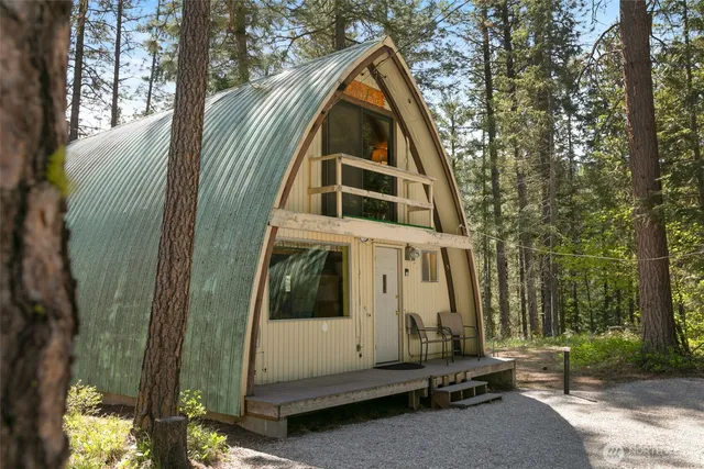 a living room with furniture a window and a chandelier