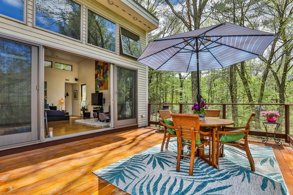 74 Woodside Road Harvard, MA 01451 - Photo 26 of 42 a view of a patio with table and chairs under an umbrella