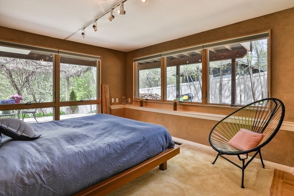 74 Woodside Road Harvard, MA 01451 - Photo 31 of 42 a bedroom with bed and glass windows