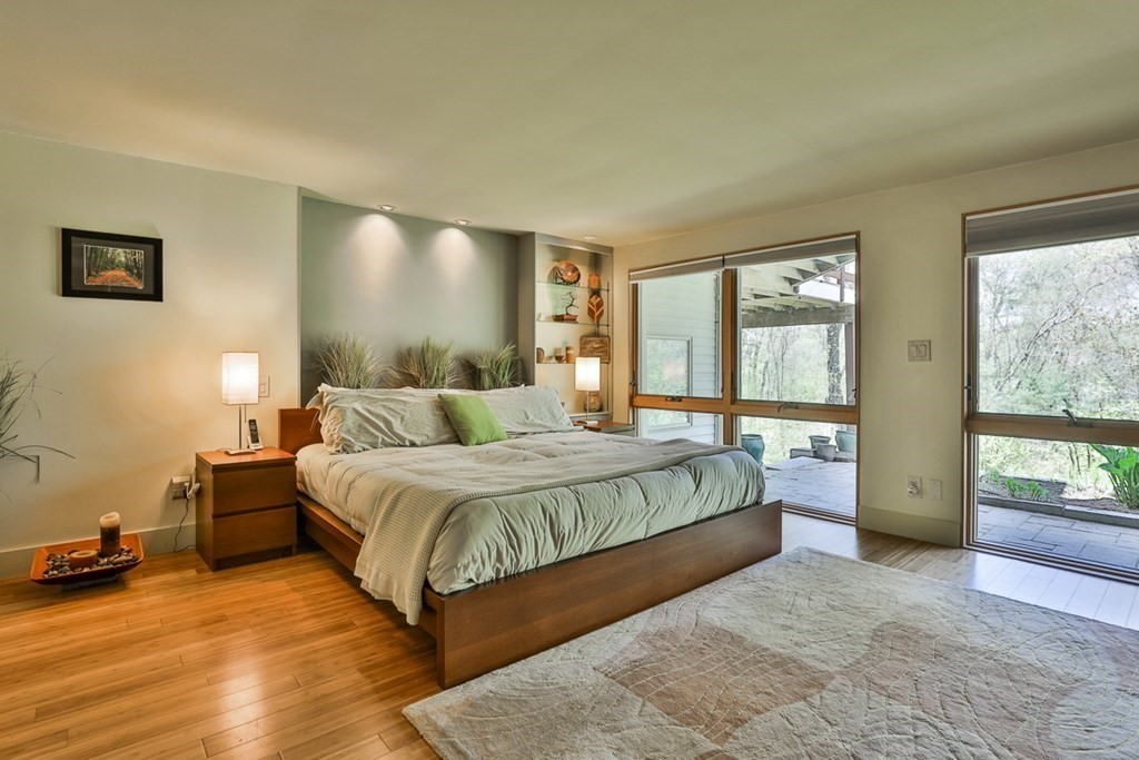 74 Woodside Road Harvard, MA 01451 - Photo 35 of 42 a spacious bedroom with a bed and wooden floor