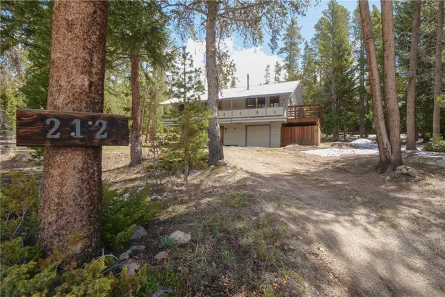 a view of house with outdoor space and trees