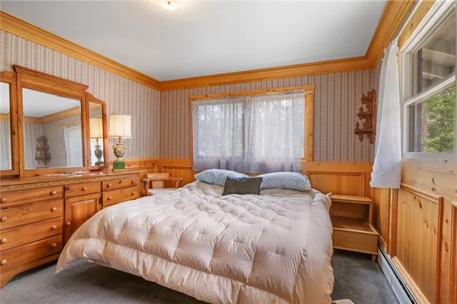 a bedroom with a bed and a large window