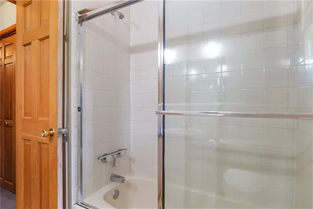 a bathroom with a glass shower door