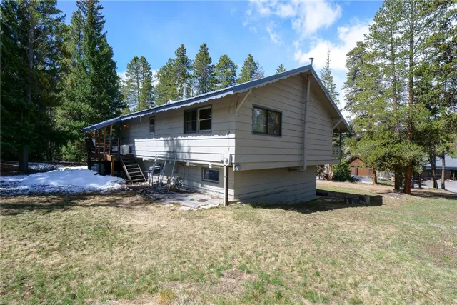 a view of a house with a yard and sitting area
