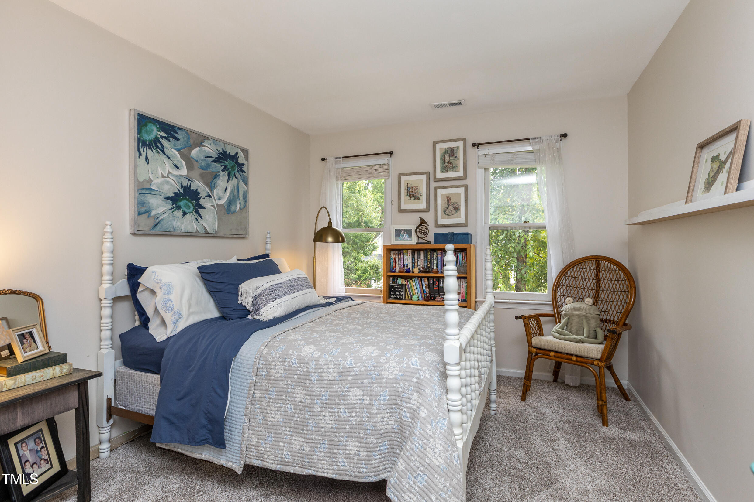 12116 Queensbridge Court Raleigh, NC 27613 - Photo 11 of 16 a bed room with a bed and a chair