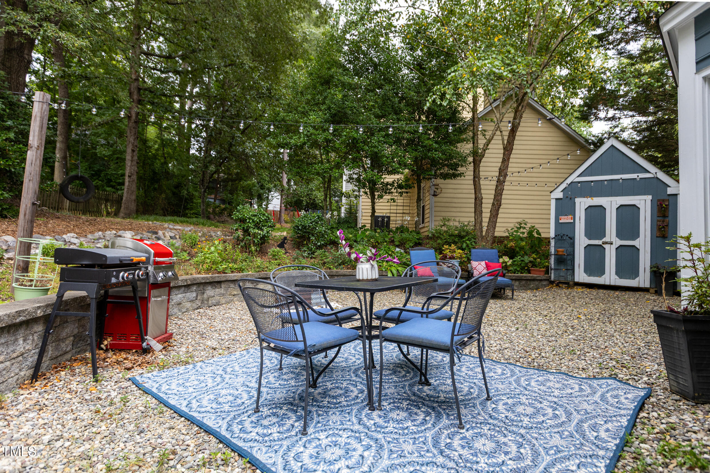 12116 Queensbridge Court Raleigh, NC 27613 - Photo 14 of 16 a view of a house with backyard sitting area and garden
