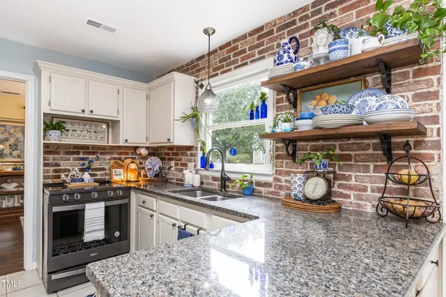 a kitchen with a stove a cabinets and a stove top oven