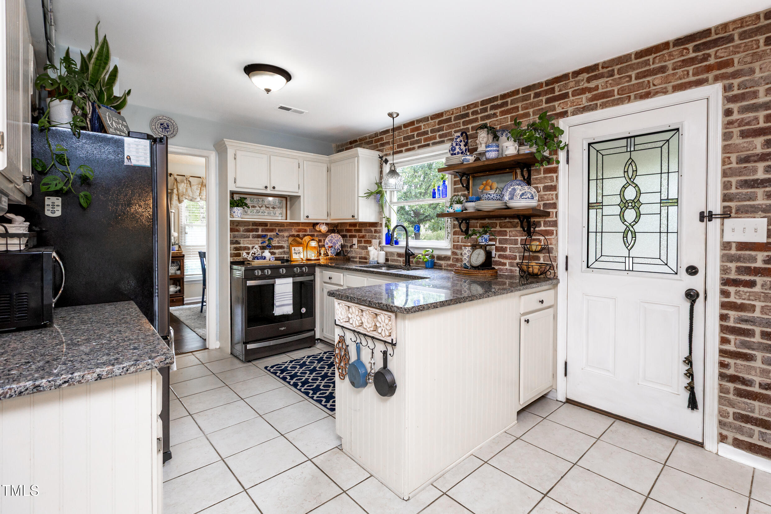 12116 Queensbridge Court Raleigh, NC 27613 - Photo 3 of 16 a kitchen with stainless steel appliances granite countertop a refrigerator and a sink