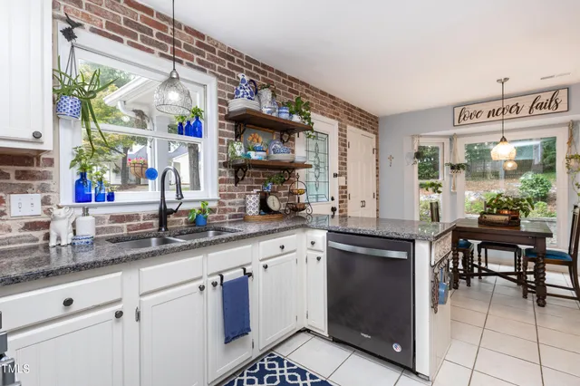 a kitchen with stainless steel appliances granite countertop a sink and cabinets