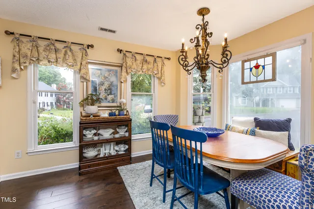 a view of a dining room with furniture wooden floor and chandelier