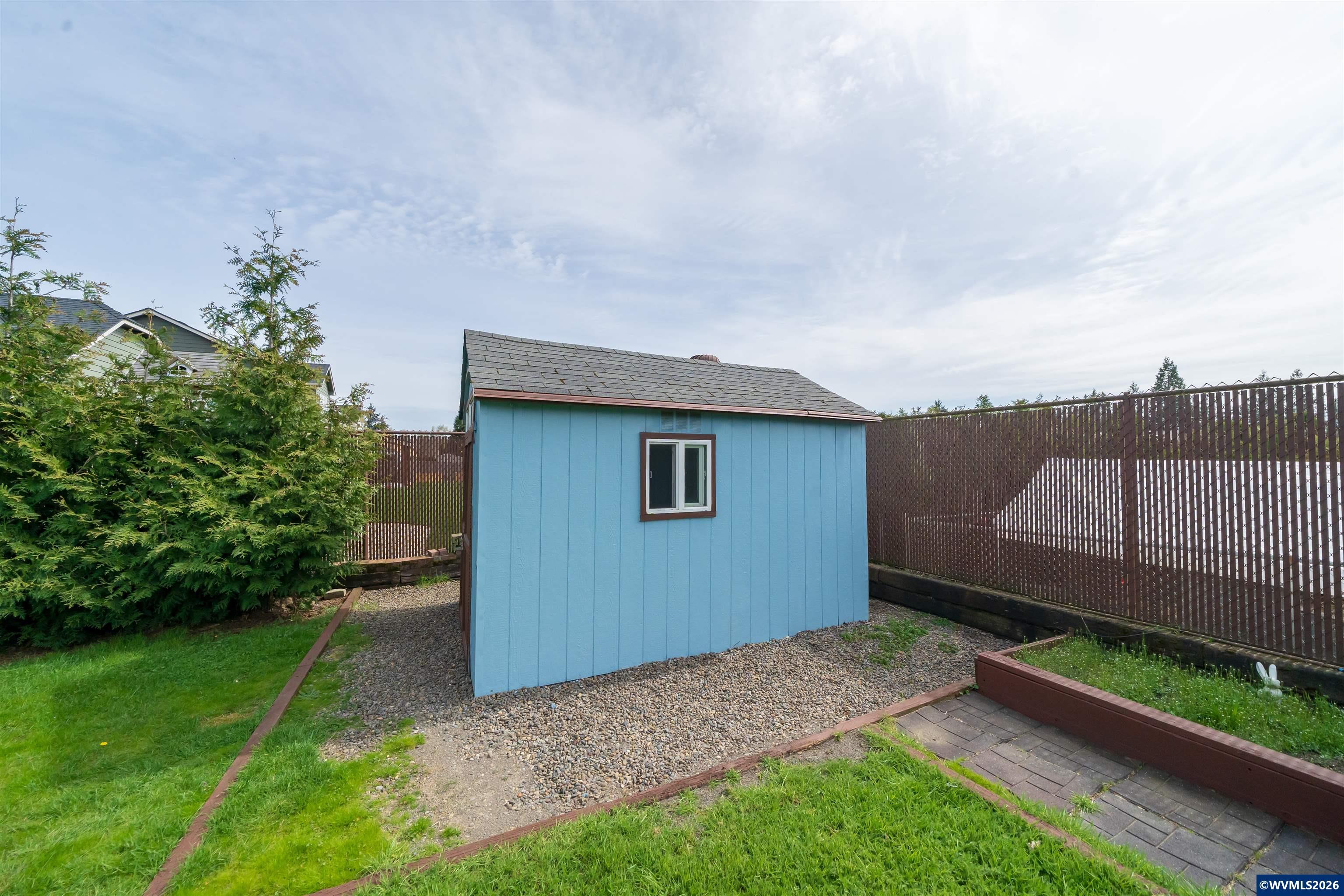 312 Southwest Cascade Meadow Drive Sublimity, OR 97385 - Photo 42 of 42 a view of backyard with a garden and deck