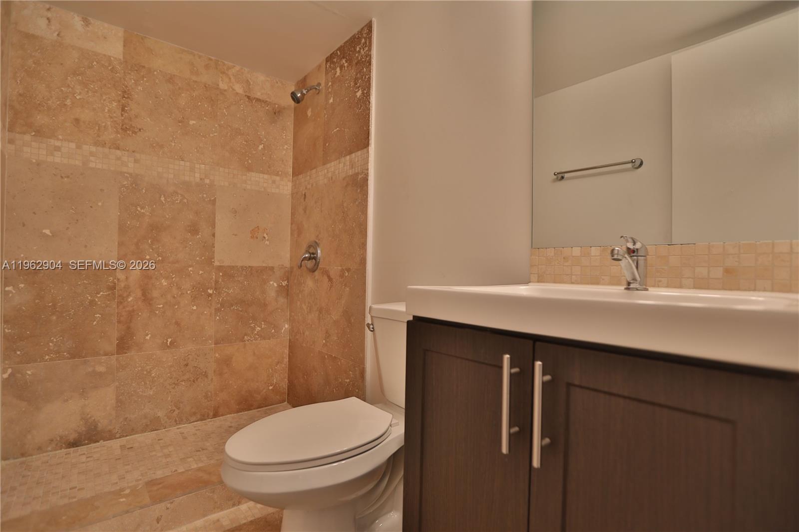 600 Northeast 36th Street, Unit 507 Miami, FL 33137 - Photo 13 of 23 a bathroom with a sink a toilet and shower