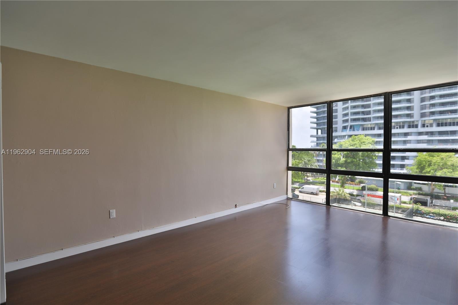 600 Northeast 36th Street, Unit 507 Miami, FL 33137 - Photo 9 of 23 an empty room with wooden floor and windows