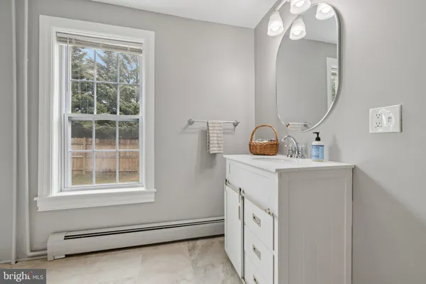 a room with a mirror and a fan