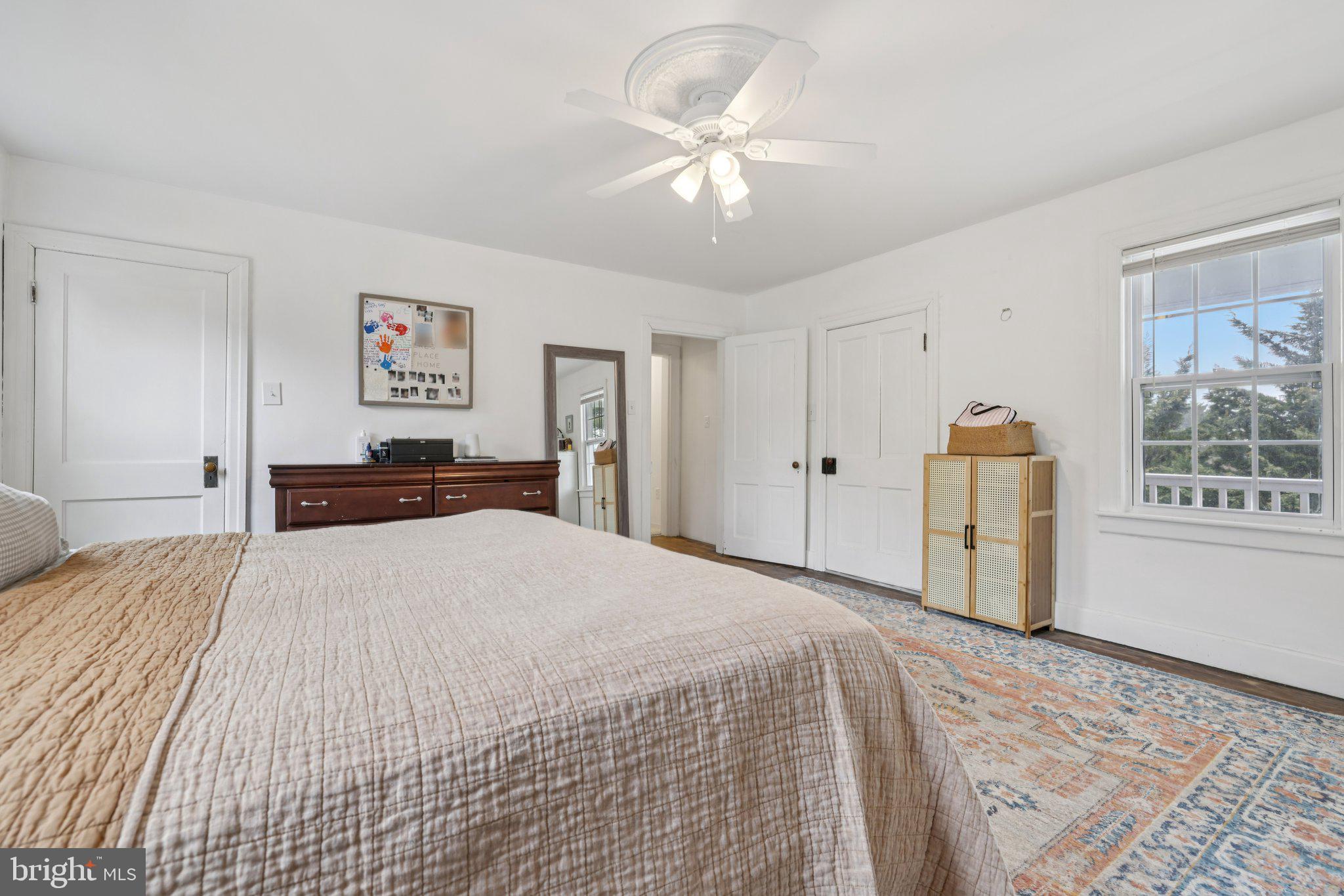 22538 Old Georgetown Road Smithsburg, MD 21783 - Photo 24 of 50 a bedroom with a large bed a chandelier and dresser