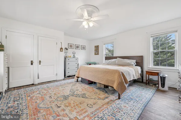 a bedroom with a large bed and a window