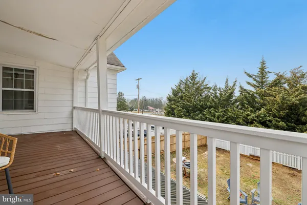 a view of a balcony with wooden floor and fence