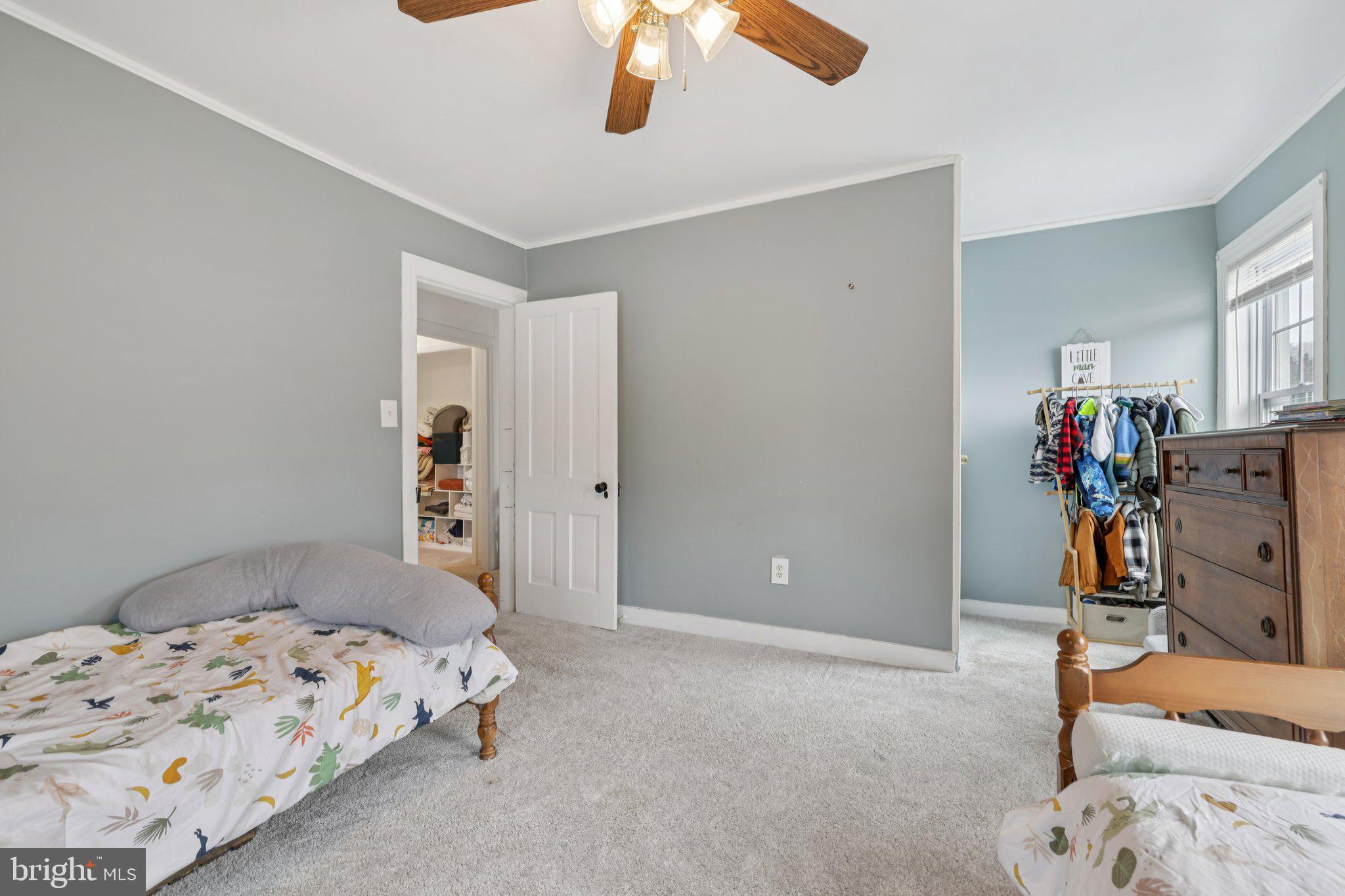 22538 Old Georgetown Road Smithsburg, MD 21783 - Photo 30 of 50 a bedroom with a bed and a chandelier