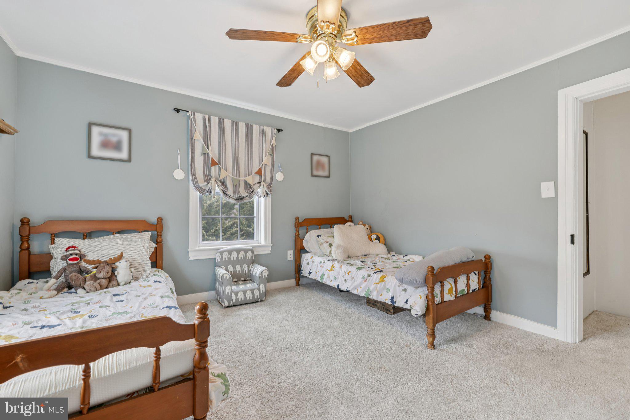 22538 Old Georgetown Road Smithsburg, MD 21783 - Photo 31 of 50 a bedroom with a bed and a chandelier