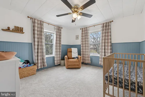 a bedroom with furniture and a large window
