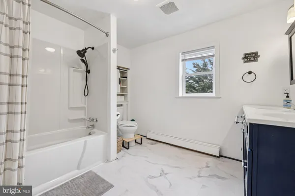 a bathroom with a bathtub and a shower