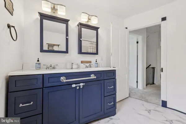 a bathroom with a double vanity sink mirror and