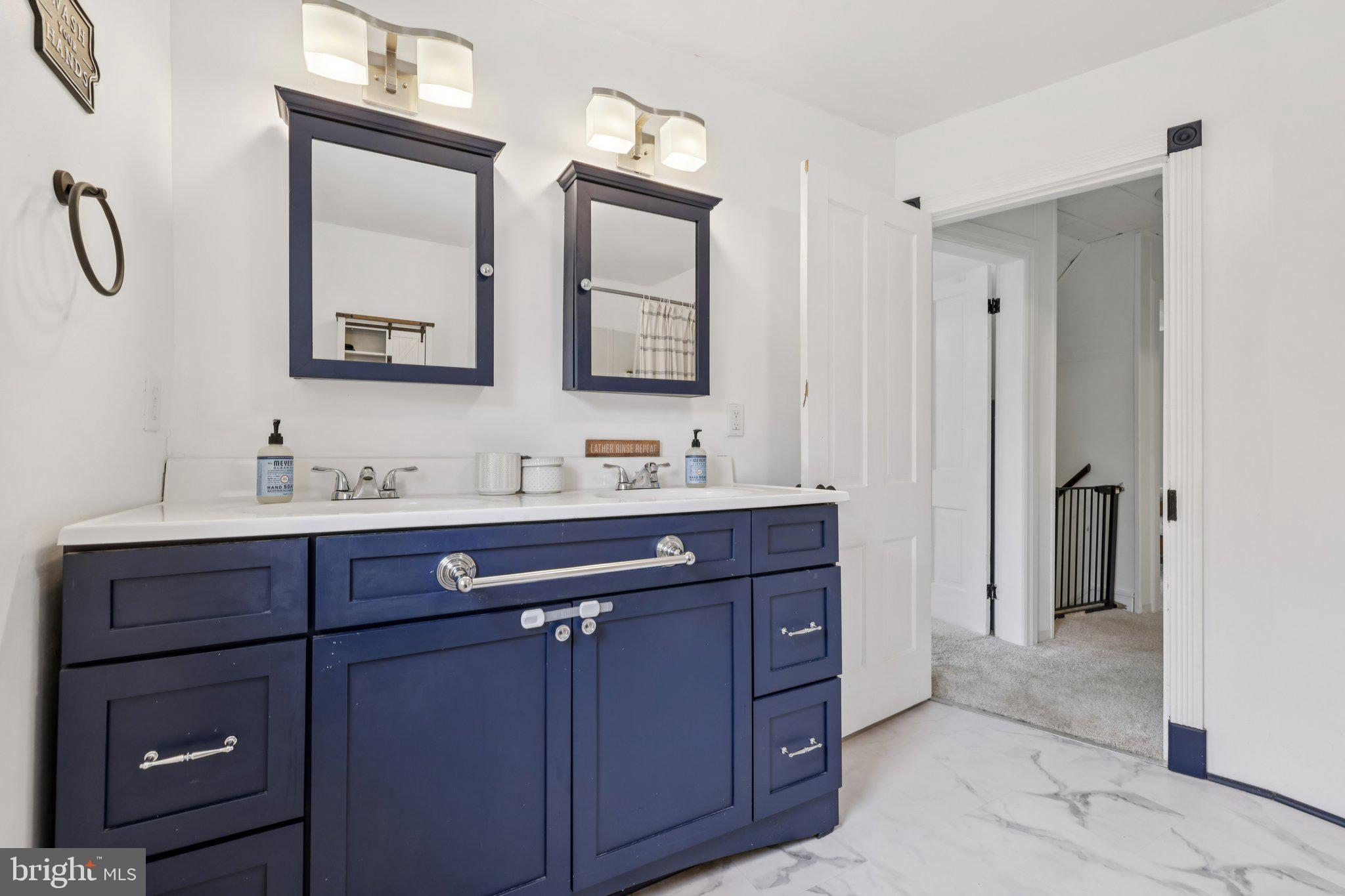 22538 Old Georgetown Road Smithsburg, MD 21783 - Photo 35 of 50 a bathroom with a double vanity sink mirror and