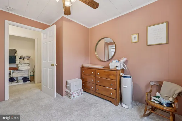 a view of a white house with table and chairs