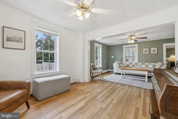 a living room with furniture and a wooden floor