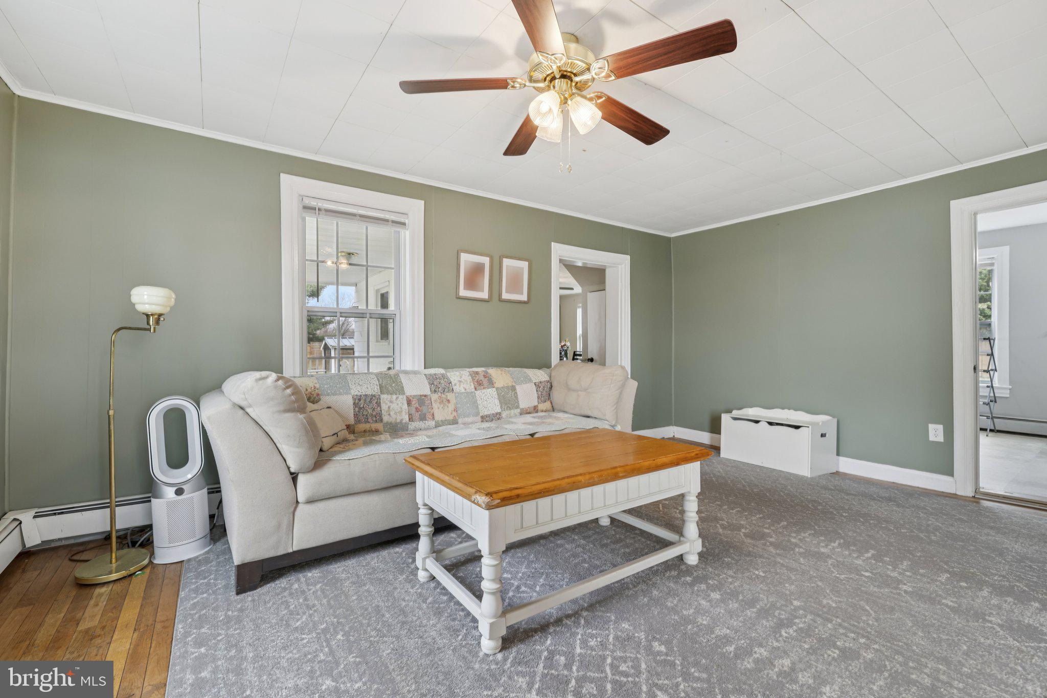 22538 Old Georgetown Road Smithsburg, MD 21783 - Photo 10 of 50 a bedroom with a bed and a chandelier