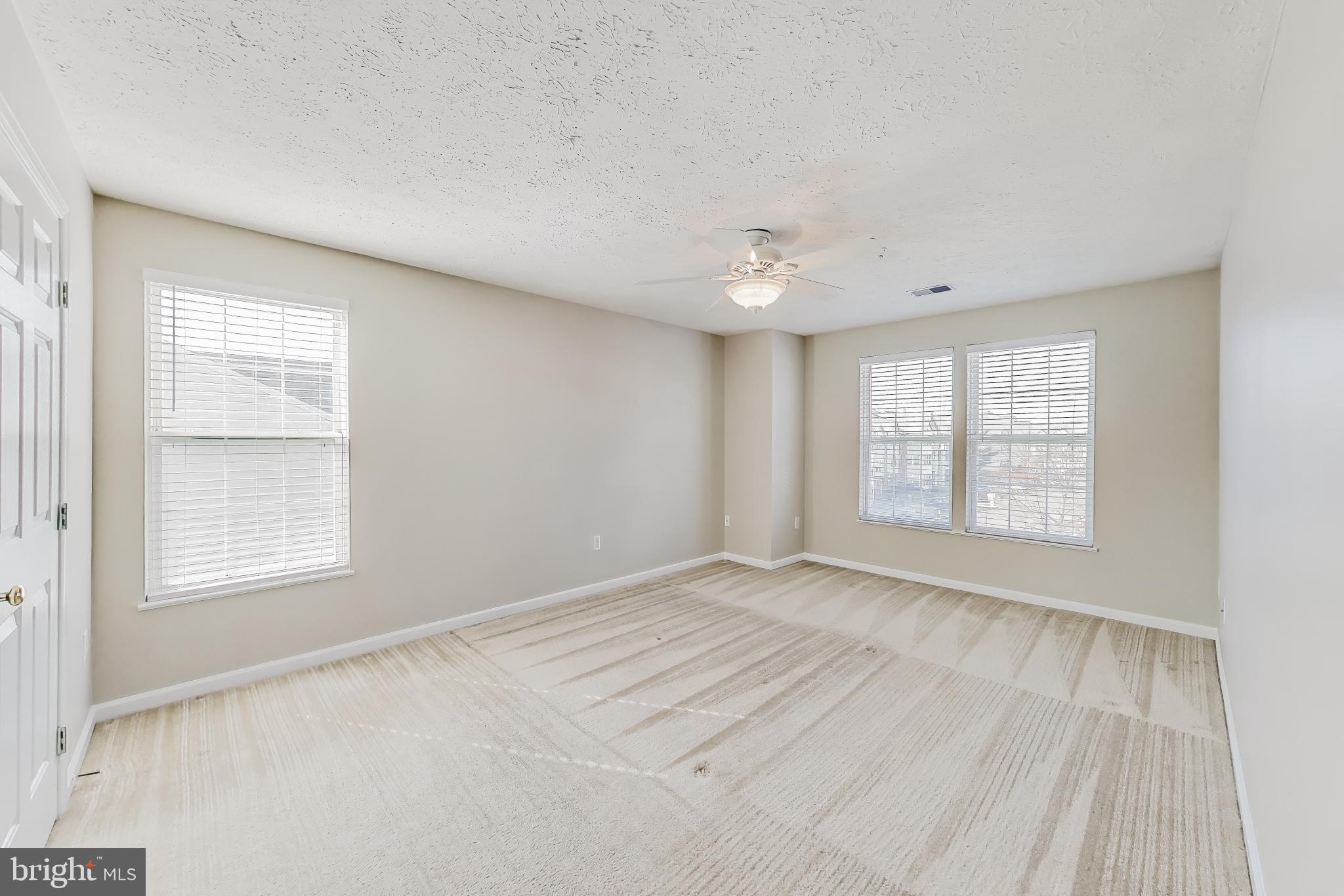 687 Winding Stream Way, Unit 304 Odenton, MD 21113 - Photo 11 of 33 an empty room with windows