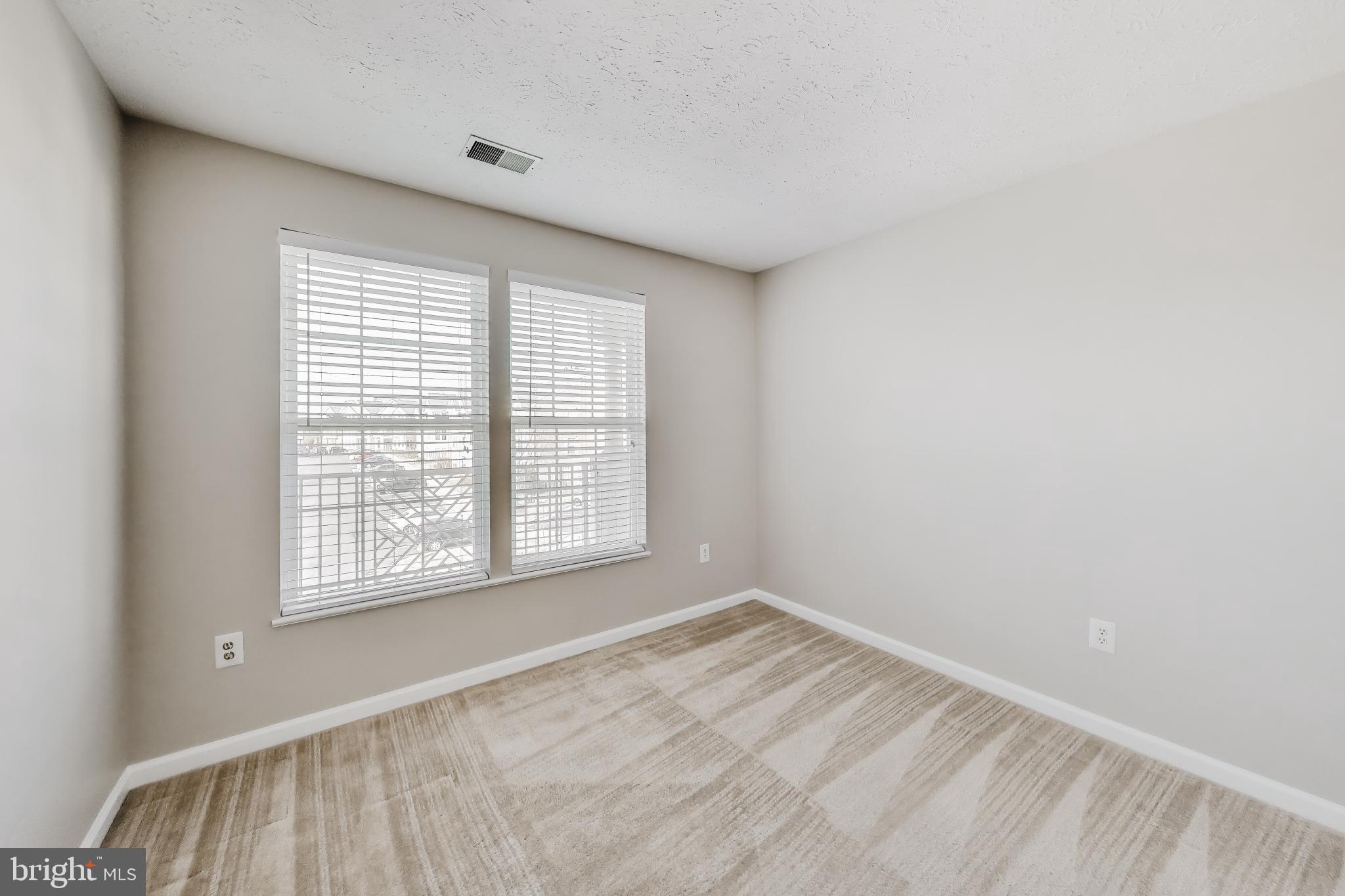 687 Winding Stream Way, Unit 304 Odenton, MD 21113 - Photo 15 of 33 a view of an empty room with a window